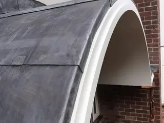 Curved lead roof above an arched entrance